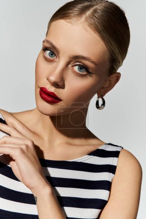 Photo for Woman in a striped swimsuit and orange lipstick. - Royalty Free Image