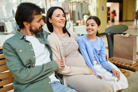 A cheerful family enjoying a break on a bench in a bustling shopping mall.