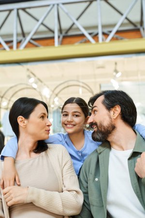Una familia feliz comparte un momento de conexión, mirándose cariñosamente durante su salida de compras en el centro comercial.