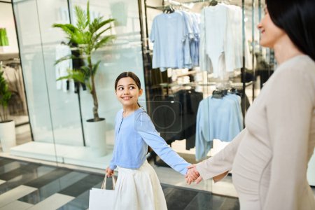 A joyful mother and daughter walk hand in hand in a lively shopping mall, enjoying a fun family outing together.
