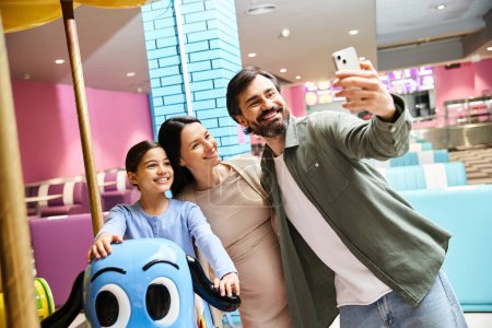 A joyful family smiles while taking a selfie amidst colorful toys in a vibrant toy store at the mall on the weekend.