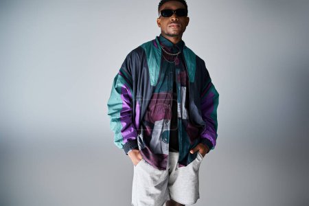 Photo for Handsome African American man in colorful jacket and shorts strikes a pose. - Royalty Free Image