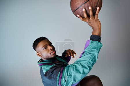 Photo for Fashionable African American man holding a basketball. - Royalty Free Image