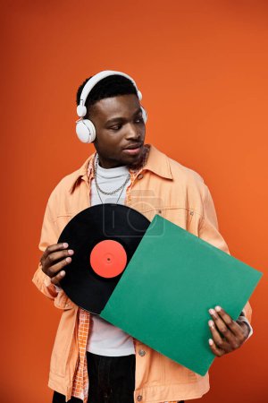Stylish, black man with headphones and record.