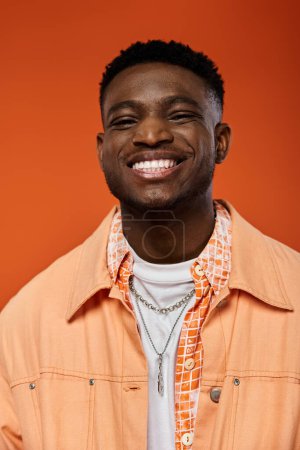 Photo for Handsome African American man in trendy attire, sporting an orange jacket and white shirt. - Royalty Free Image