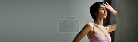 Photo for A woman in a pink dress gracefully posing. - Royalty Free Image