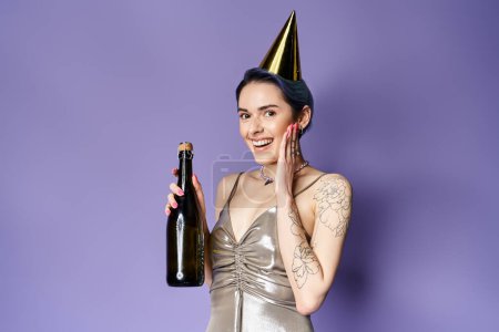 A young woman with short blue hair wearing a silver party dress, holding a bottle of champagne and a festive party hat.