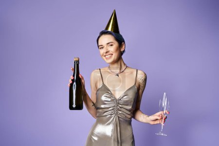 Téléchargez les photos : A stylish young woman with blue hair elegantly holding a bottle of champagne and a wine glass in a silver party dress. - en image libre de droit