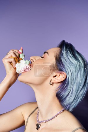 A stylish young woman with blue hair enjoying a decadent slice of cake in a glamorous setting.