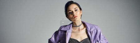 Photo for A young birthday girl with short dyed hair strikes a pose in a stylish purple jacket in a studio setting. - Royalty Free Image