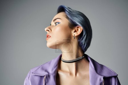 A young woman with striking blue hair striking a pose in a sleek purple jacket, exuding style and charisma.