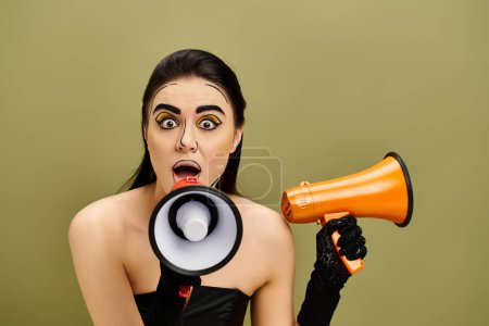A surprised pretty brunette woman, styled in pop art makeup, holds a megaphone with a shocked expression.