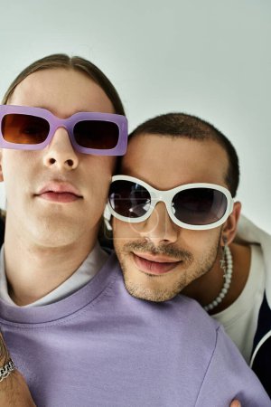 A stylish two men confidently sport purple sunglasses.