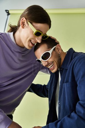 A trendy gay couple enjoying quality time together while posing in sunglasses.