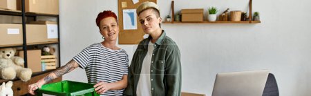 A young lesbian couple working together in an office setting.