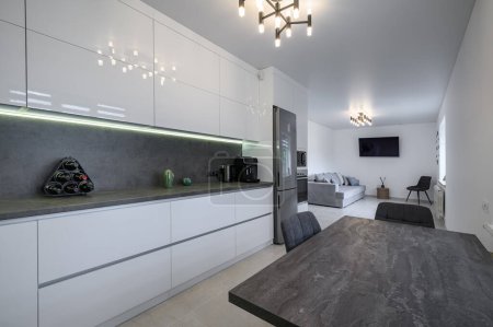 Foto de Luxurious modern trendy white and grey kitchen interior after renovation, with granite counter top - Imagen libre de derechos