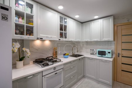 Foto de Primer plano de los nuevos muebles de cocina modernos blancos y grises bien diseñados - Imagen libre de derechos