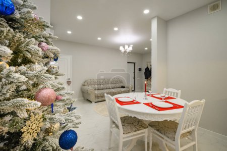 Photo for Interior of bright dinner room decorated with Christmas tree - Royalty Free Image