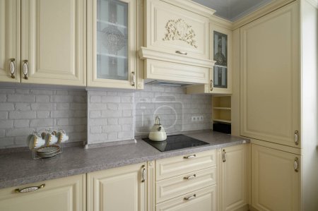 Téléchargez les photos : Real showcase interior of modern trendy cream colored kitchen - en image libre de droit