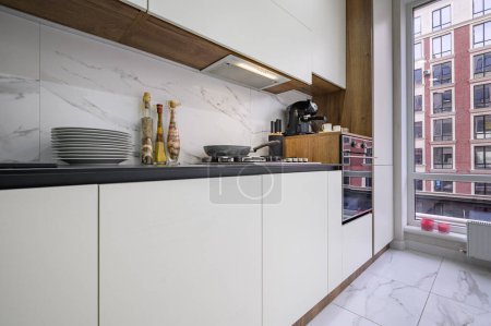 Photo for Black and white modern luxury kitchen interior with large window - Royalty Free Image