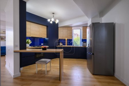 Téléchargez les photos : Stylish large studio apartment with kitchen open to living room after good renovation - en image libre de droit