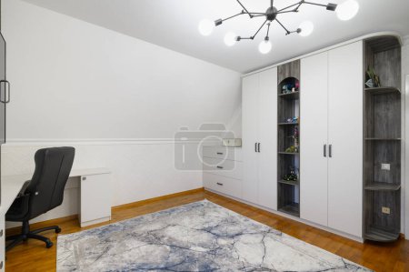 Photo for Large white cabinet and sideboard and workplace in living room with wooden floor - Royalty Free Image