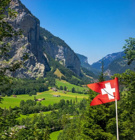 Photo for Scenic view on the Lauternbrunen valley with Swiis flag in Swiss alps in the summer - Royalty Free Image