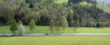 porsche sur la route dans la vallée du printemps près de Winterberg en sauerland allemand et beau paysage rural