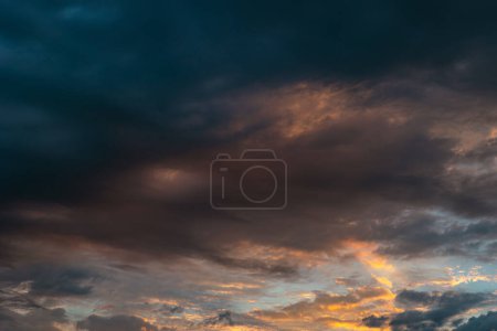 Dramatic or cinematic clouds at sunrise. Morning cloudscape. Dark clouds or storm concept photo.