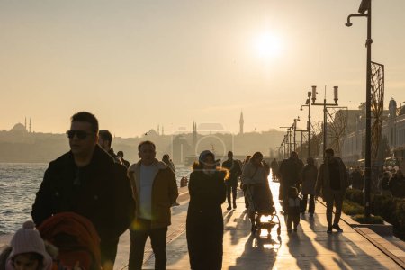 Photo for People walking on the pier of Galataport at sunset. Travel to Istanbul background photo. Istanbul Turkiye - 12.24.2022 - Royalty Free Image