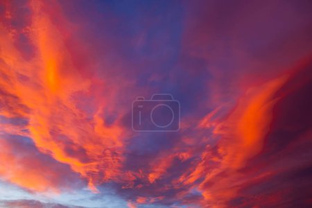 Dramatic orange clouds at sunset. Cloudscape with amazing clouds. Earth Day concept background photo.