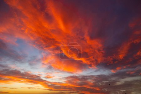 Cloudscape at sunset. Orange clouds at sunset or sunrise. Earth Day background concept photo.