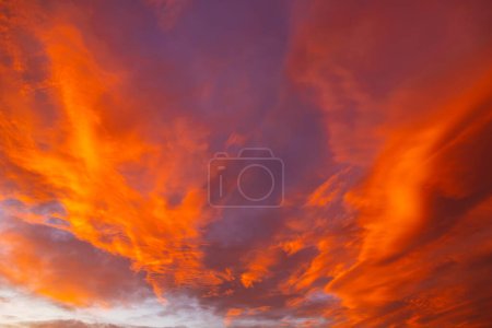 Dramatic orange clouds at sunset. Sunset cloudscape. Earth Day concept photo.