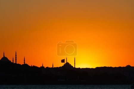 Silhouette of mosques and city at sunset. Istanbul silhouette. Ramadan or laylat al-qadr or kadir gecesi background photo.