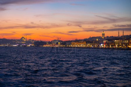 Photo for Istanbul view at sunset. Istanbul cityscape from a ferry. Suleymaniye Mosque and Galata Tower with Galataport in view. - Royalty Free Image