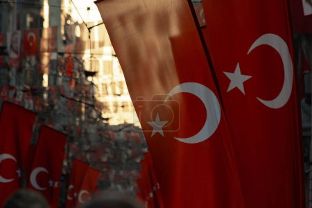 Photo for Turkish flags in focus on the street at sunset. National holidays of Turkiye concept photo. Selective focus. - Royalty Free Image