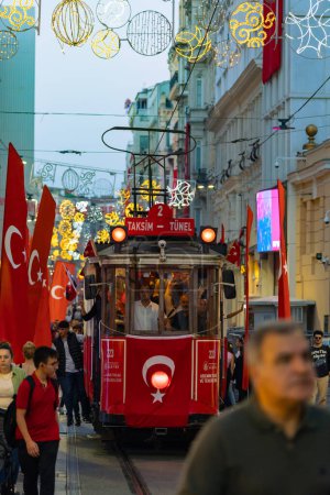 Photo for Turkish national holidays concept vertical photo. Nostalgic tramway and flags in Istiklal Avenue. Istanbul Turkiye - 10.28.2023 - Royalty Free Image