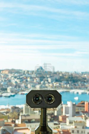 Visit Istanbul concept vertical photo. Binoculars and Istanbul view on the background.
