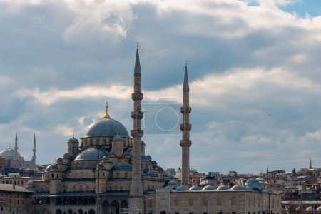 Ramadan or islamic background photo. Eminonu New Mosque or Yeni Cami with cloudy sky.