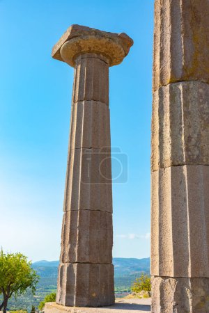 Columns of the Temple of Athena in Assos ancient city in Canakkale Turkiye. Visit Turkey concept vertical photo.