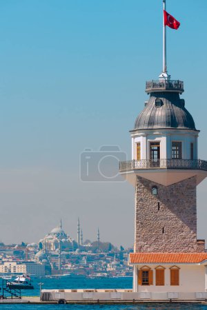 Kiz Kulesi or Maiden's Tower with Suleymaniye Mosque in vertical shot. Visit Istanbul background vertical photo.