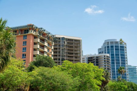 Photo for Views of modern residential buildings against the sky at Miami, Florida. There are trees below and views of apartments and condos with balconies at the back. - Royalty Free Image