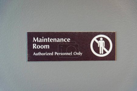 Photo for Destin, Florida- Maintenance Room Authorized Personnel Only signage. Brown sign with symbol on a painted gray wall at the background. - Royalty Free Image