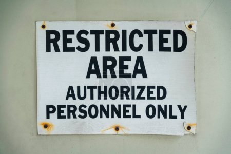Photo for Screwed signage with rust and Restricted Area Authorized Personnel Only- Miami, Florida. Close-up of a sign on a wall with black letterings. - Royalty Free Image