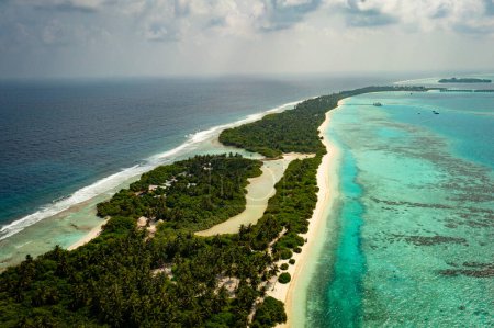 Téléchargez les photos : Une île tropicale aux Maldives avec de l'eau de mer turquoise. Destination touristique de vacances de voyage. Paysage marin pittoresque. Tournage vidéo avec un drone. - en image libre de droit