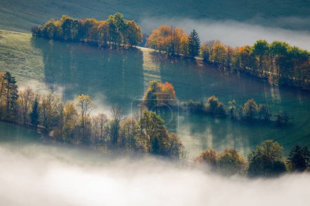 Landscape of foggy valley in an autumn morning. The Sulov Rocks, national nature reserve in northwest of Slovakia, Europe.
