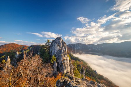 Photo for Mountain landscape with foggy valley during autumn morning. The Sulov Rocks, national nature reserve in northwest of Slovakia, Europe. - Royalty Free Image