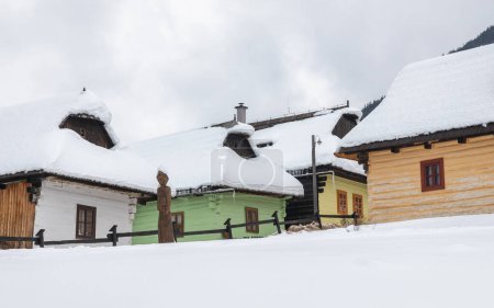 Photo for Snowy winter landscape with folk architecture. Vlkolinec village with historical colorfull wooden houses, Slovakia Europe. - Royalty Free Image