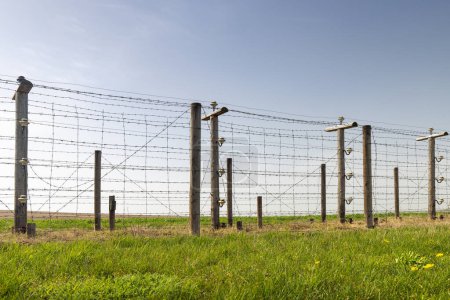 Electric barbed wire fence. Historical Area of the Czechoslovak fortification Satov for defense against Nazi Germany near Znojmo town in the South Moravian Region of the Czech Republic, Europe.