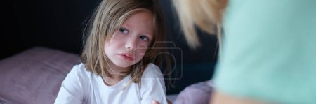 Upset sad little girl communicates with mom at home. Tactile contact of children and parents concept